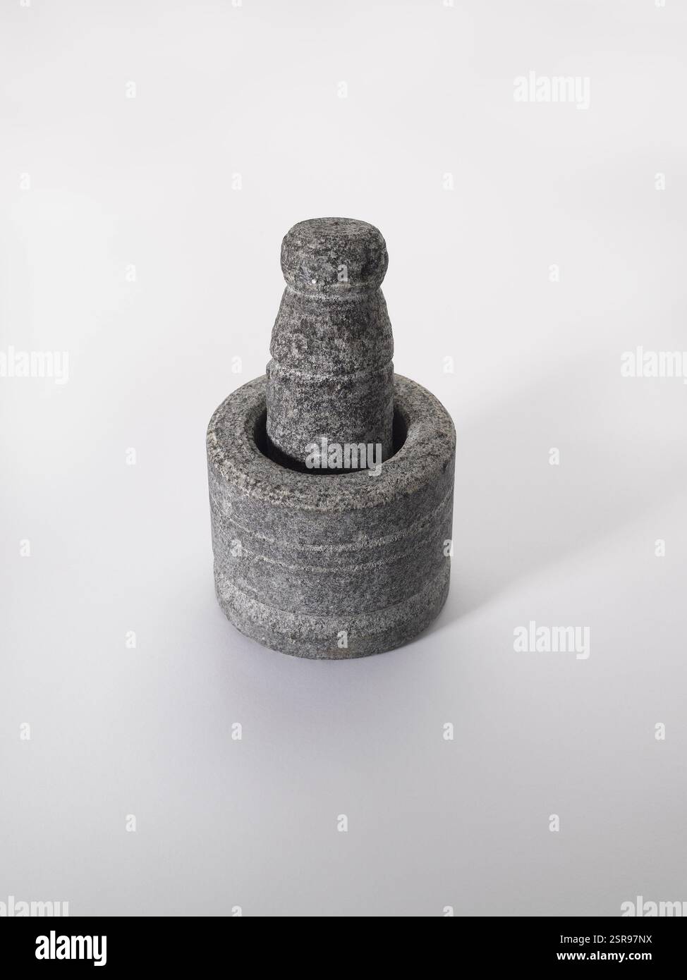 Old stone grinder on white background Stock Photo