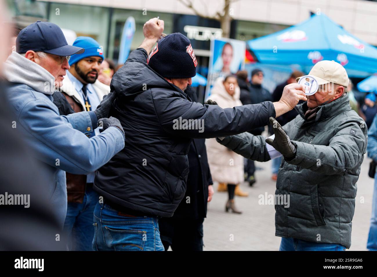 Duesseldorf, Germany. 15th Feb, 2025. A man (M) pushed back by AfD ...