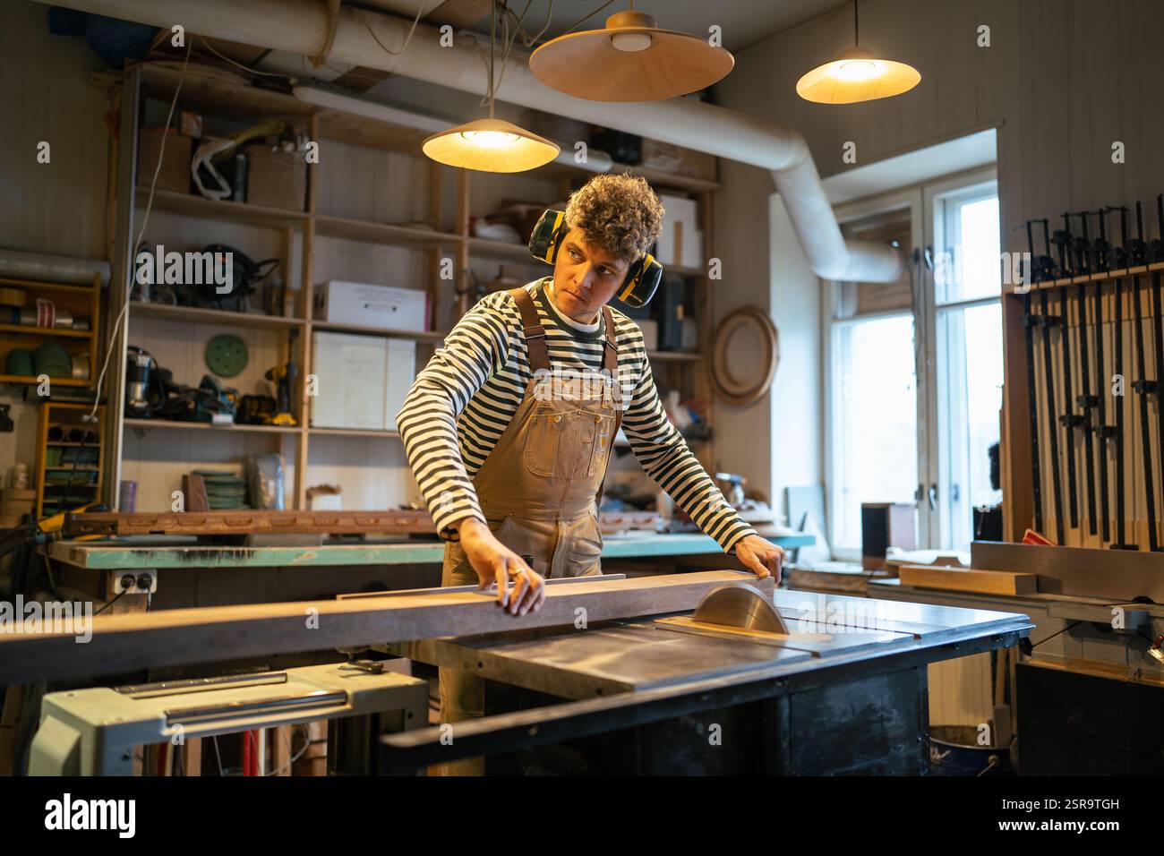 File Workshop Machine Carpentry workshop, craftsman master working. Man uses circular ...