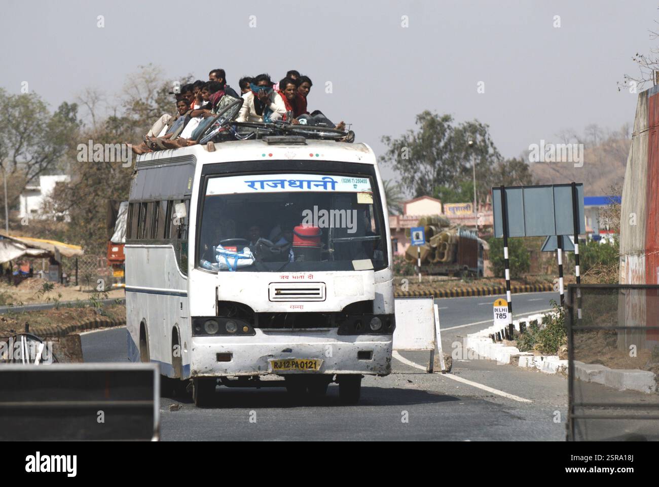 People travelling on rooftop of private transport bus on Udaipur ...