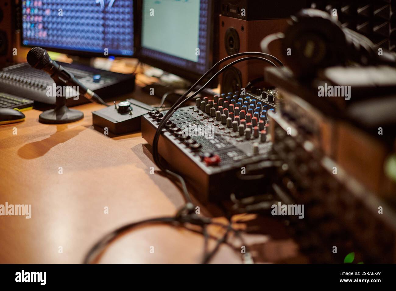 Audio mixing console with microphone in contemporary recording studio ...