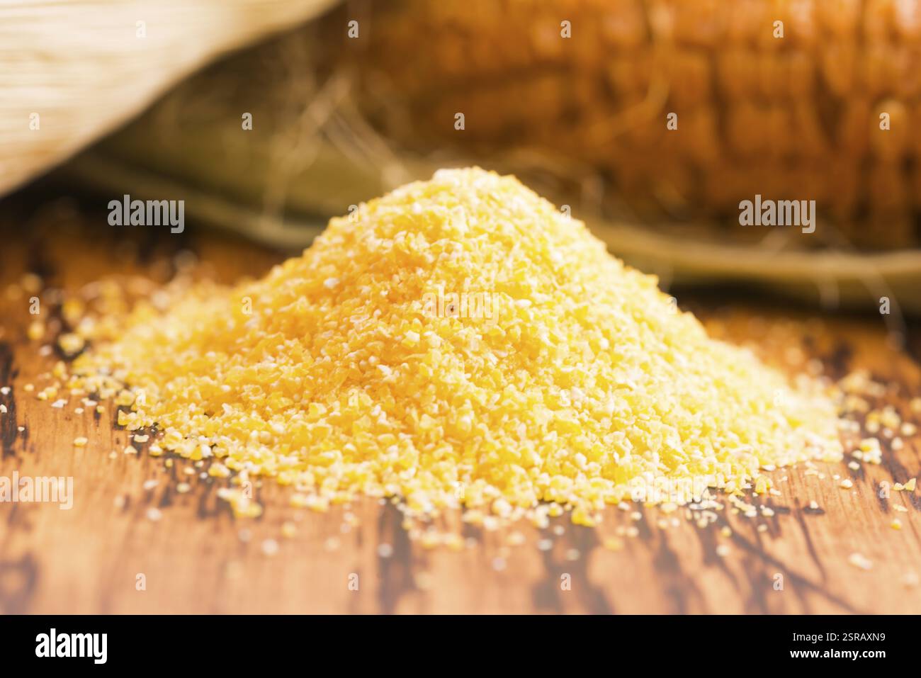 Corn groats and seeds, corncobs on wooden rustic table Stock Photo
