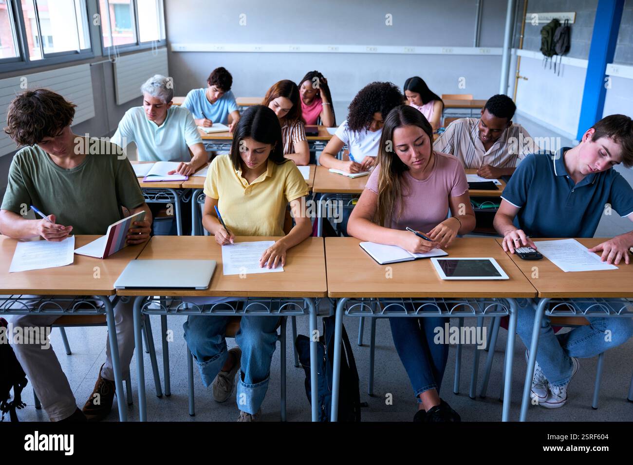 Front view of a group of multiracial students working together in a ...