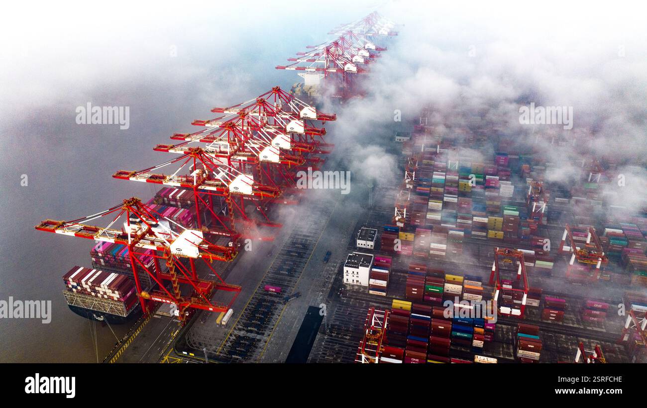 Cranes Control Tower And Cargo Ships Loom In The Yangshan Deep Water cranes-control-tower-and-cargo-ships-loom-in-the-yangshan-deep-water