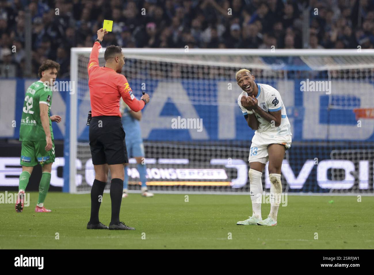 derek-cornelius-of-marseille-receives-a-yellow-card-from-referee
