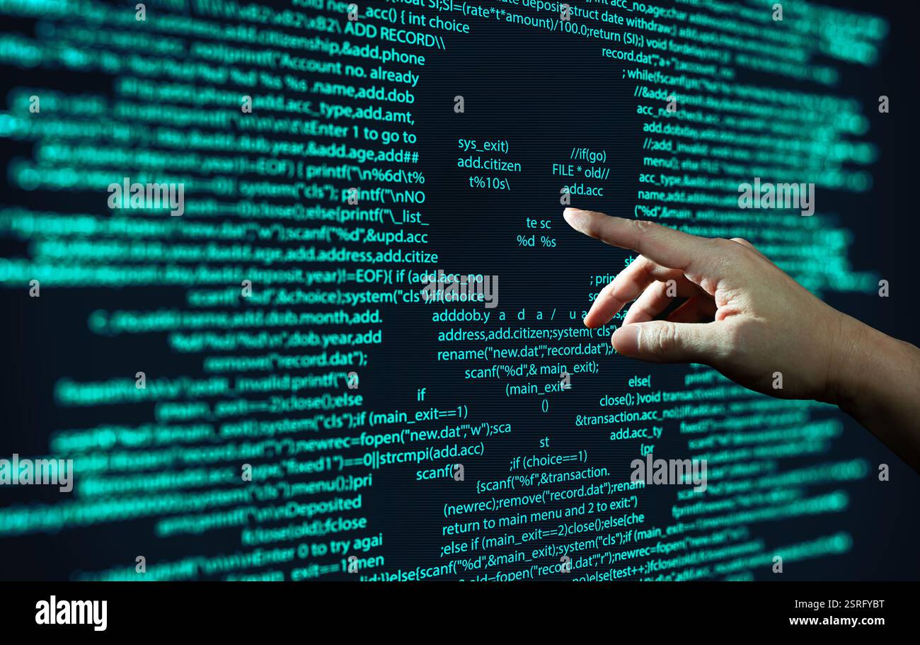 Human hand points at abstract Modern tech of Programming code screen with skull. Computer Virus, Malware, and Hacker Attack Concept. Stock Photo