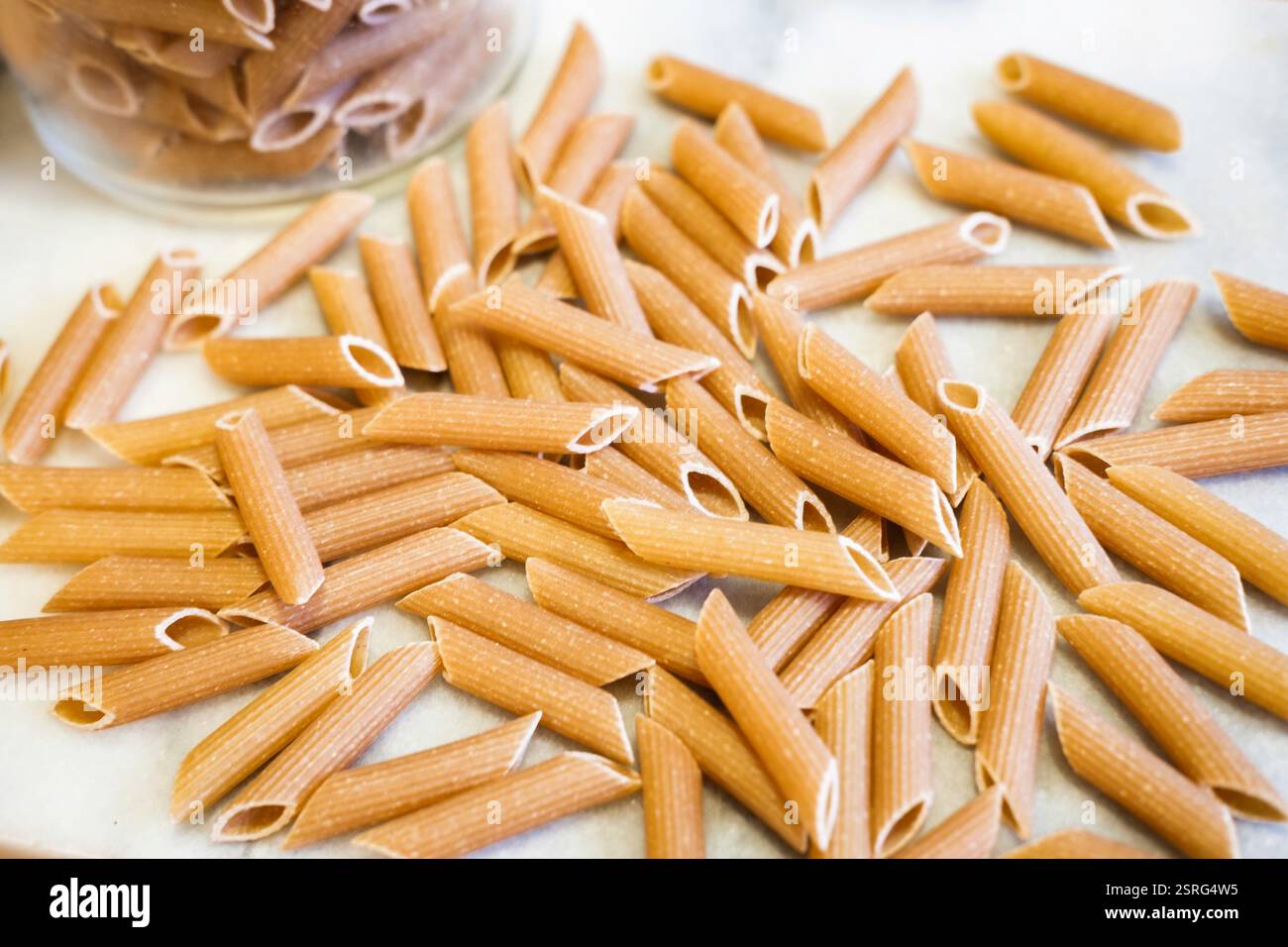 Uncooked wholewheat penne pasta Stock Photo