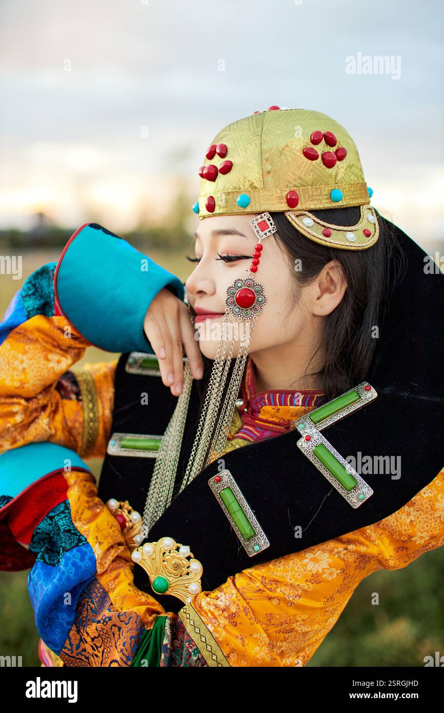 Mongolian girl wearing traditional costume of the Mongolian Ordos tribe ...