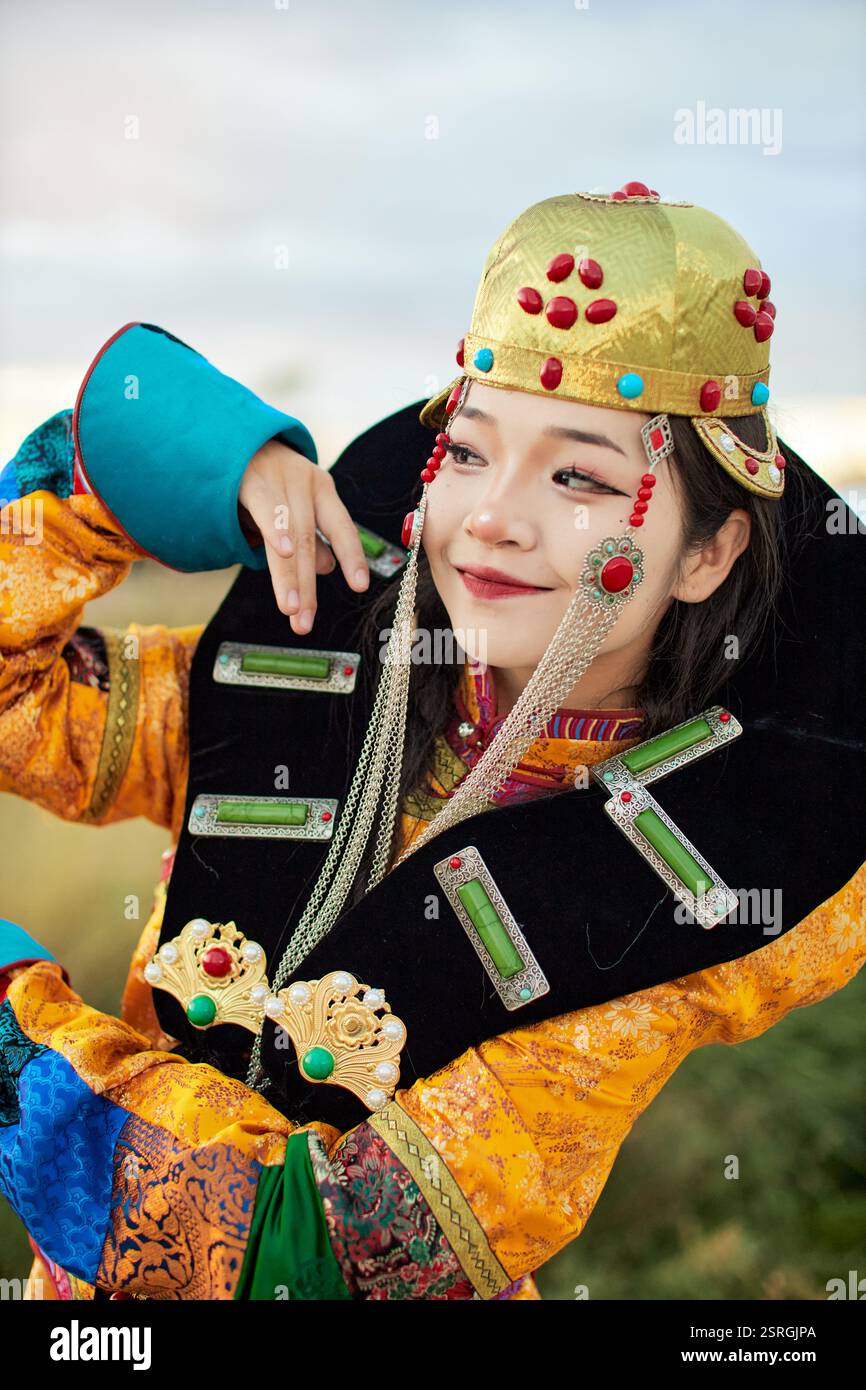 Mongolian girl wearing traditional costume of the Mongolian Ordos tribe ...
