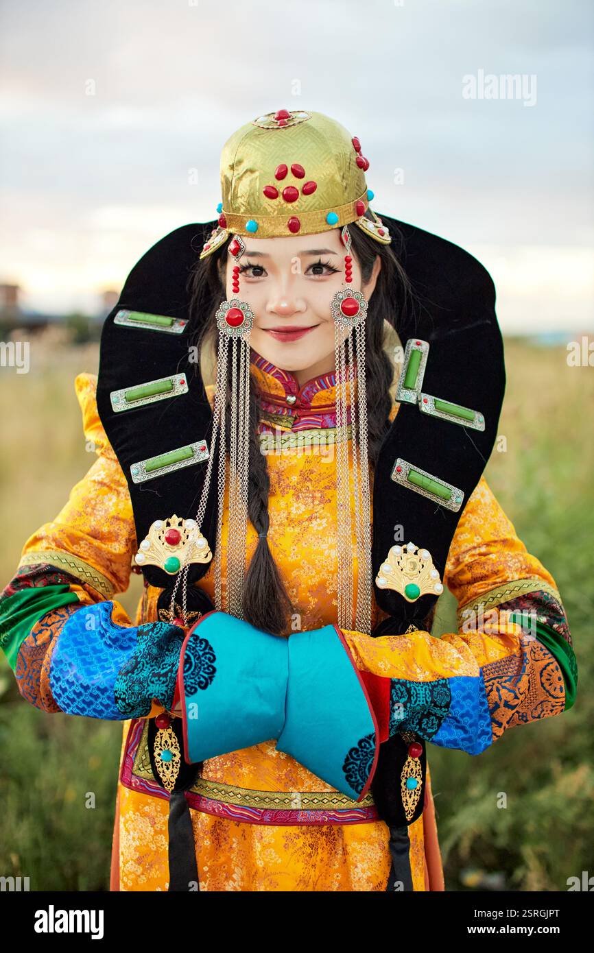 Mongolian girl wearing traditional costume of the Mongolian Ordos tribe ...