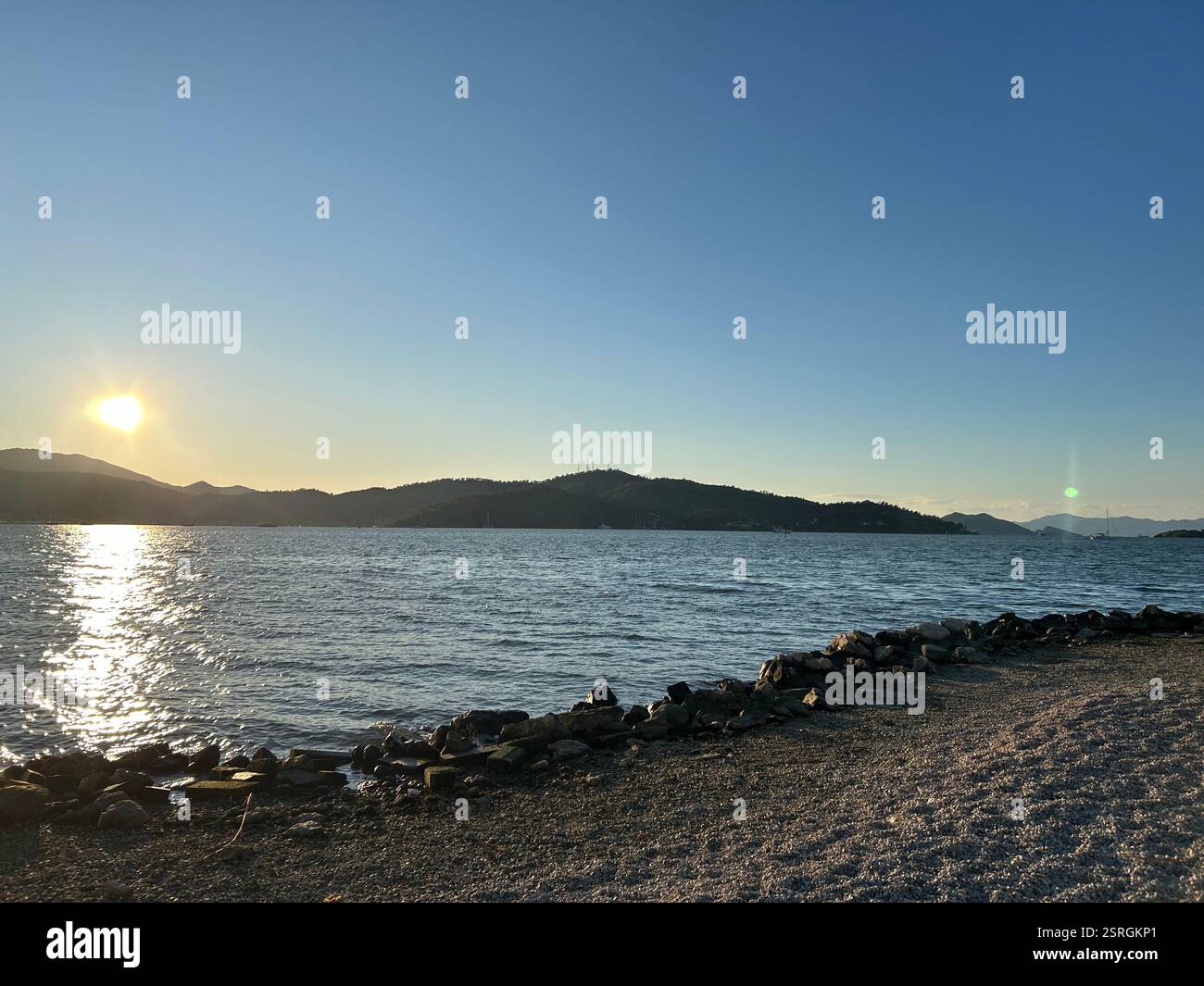 Beautiful scenic view of the sun setting over mountains and the Mediterranean Sea - Smartphone Captured Stock Image