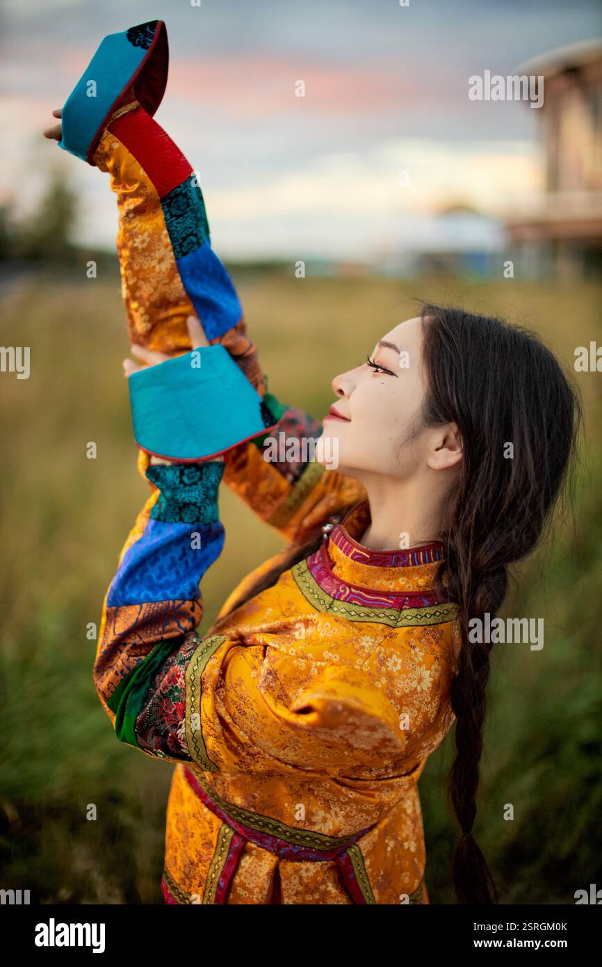 Mongolian girl wearing traditional costume of the Mongolian Ordos tribe ...