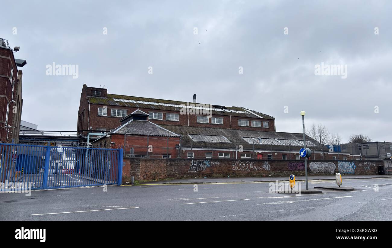 North British Distillery Building in Edinburgh. Grungy brick factory on a dull overcast day. Dirty and grimy industrial factory - Smartphone Captured Stock Image