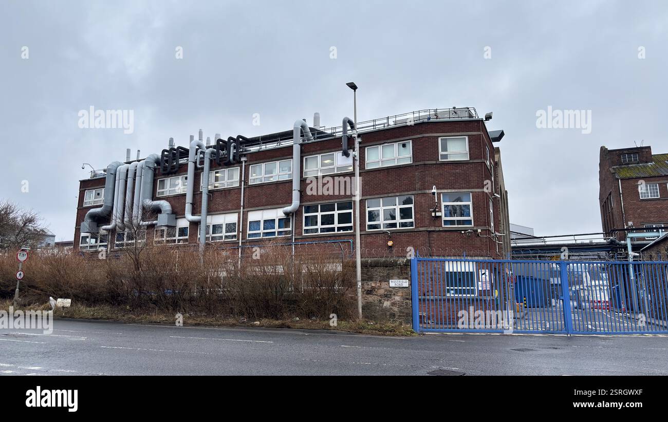 North British Distillery Building in Edinburgh. Grungy brick factory on a dull overcast day. Dirty and grimy industrial factory - Smartphone Captured Stock Image