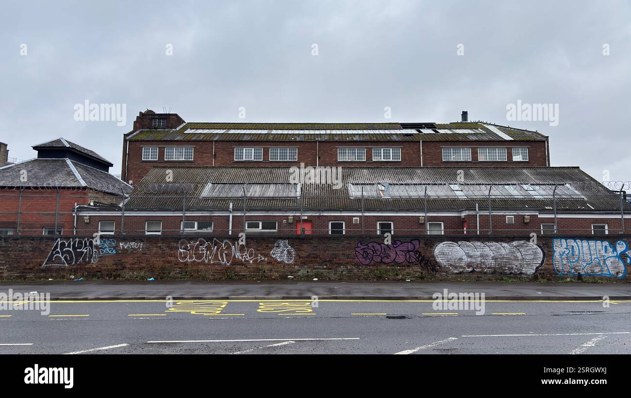 North British Distillery Building in Edinburgh. Grungy brick factory on a dull overcast day. Dirty and grimy industrial factory - Smartphone Captured Stock Image