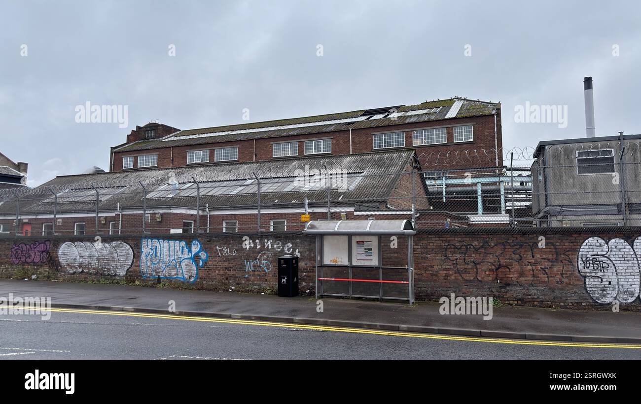 North British Distillery Building in Edinburgh. Grungy brick factory on a dull overcast day. Dirty and grimy industrial factory - Smartphone Captured Stock Image