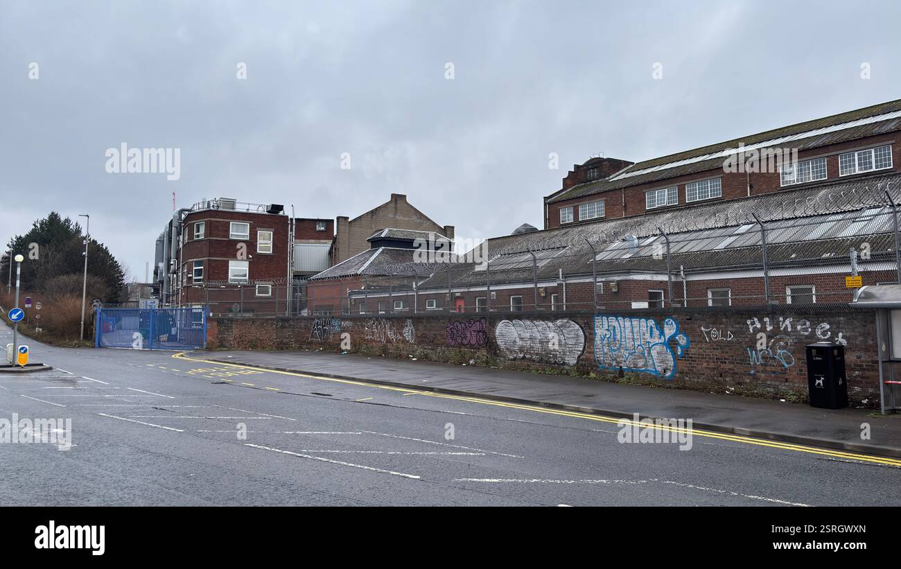 North British Distillery Building in Edinburgh. Grungy brick factory on a dull overcast day. Dirty and grimy industrial factory - Smartphone Captured Stock Image