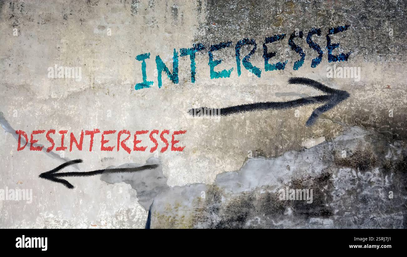 An image with a signpost pointing in two different directions in German. One direction points to interest, the other points to disinterest. Stock Photo