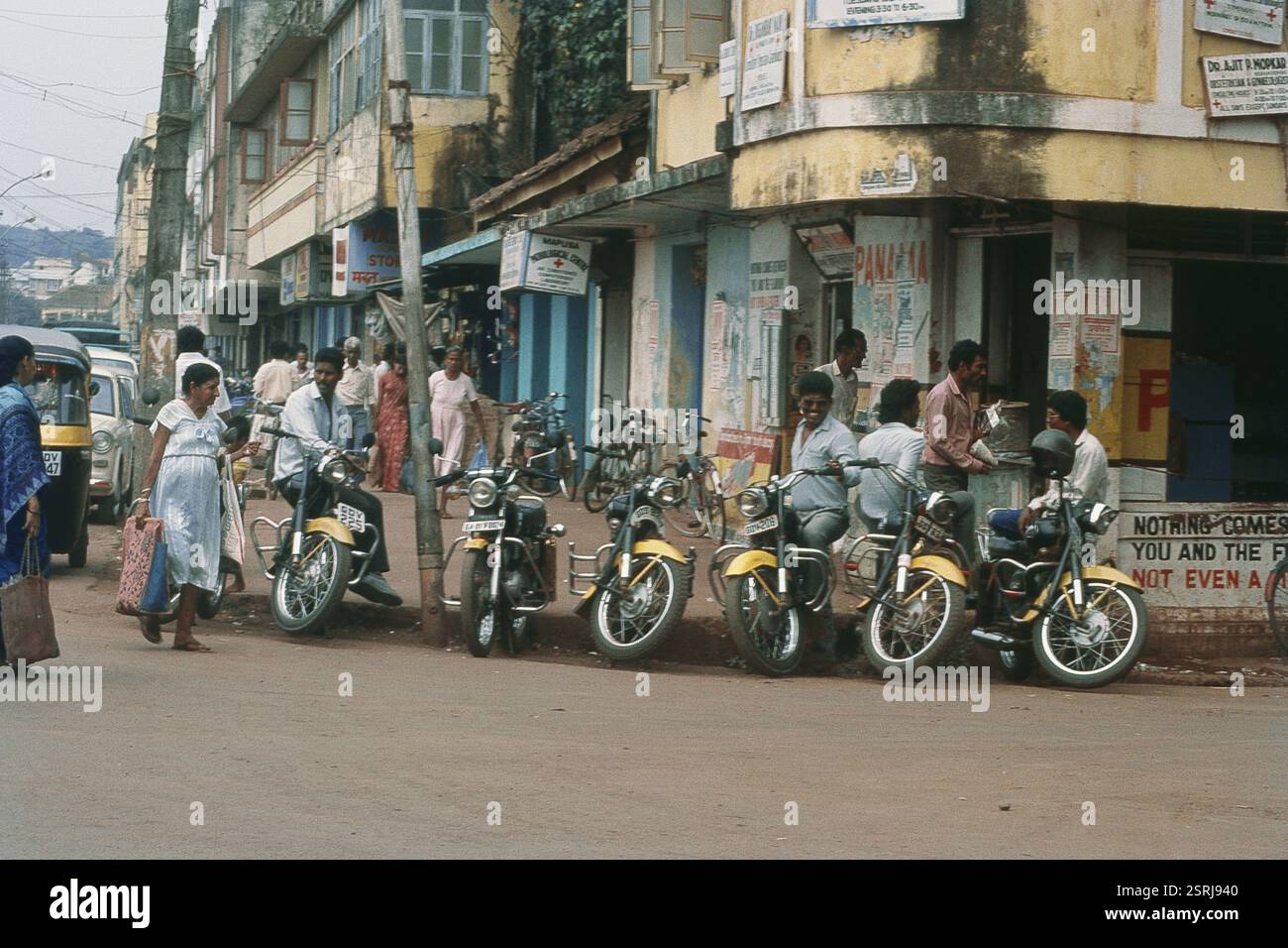 People standing near two wheeler, Mapusa, Goa, India, Asia Stock Photo