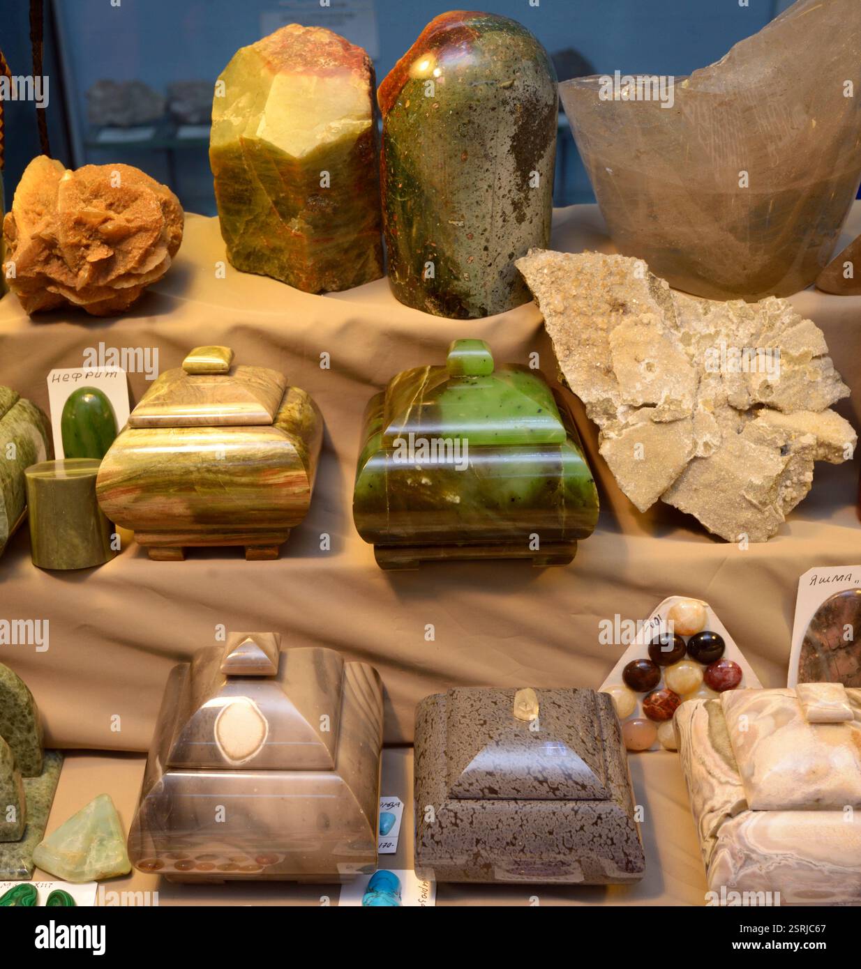 Handmade caskets made of semi-precious natural stones - jaspers, agates, nephritis- placed on the counter Stock Photo