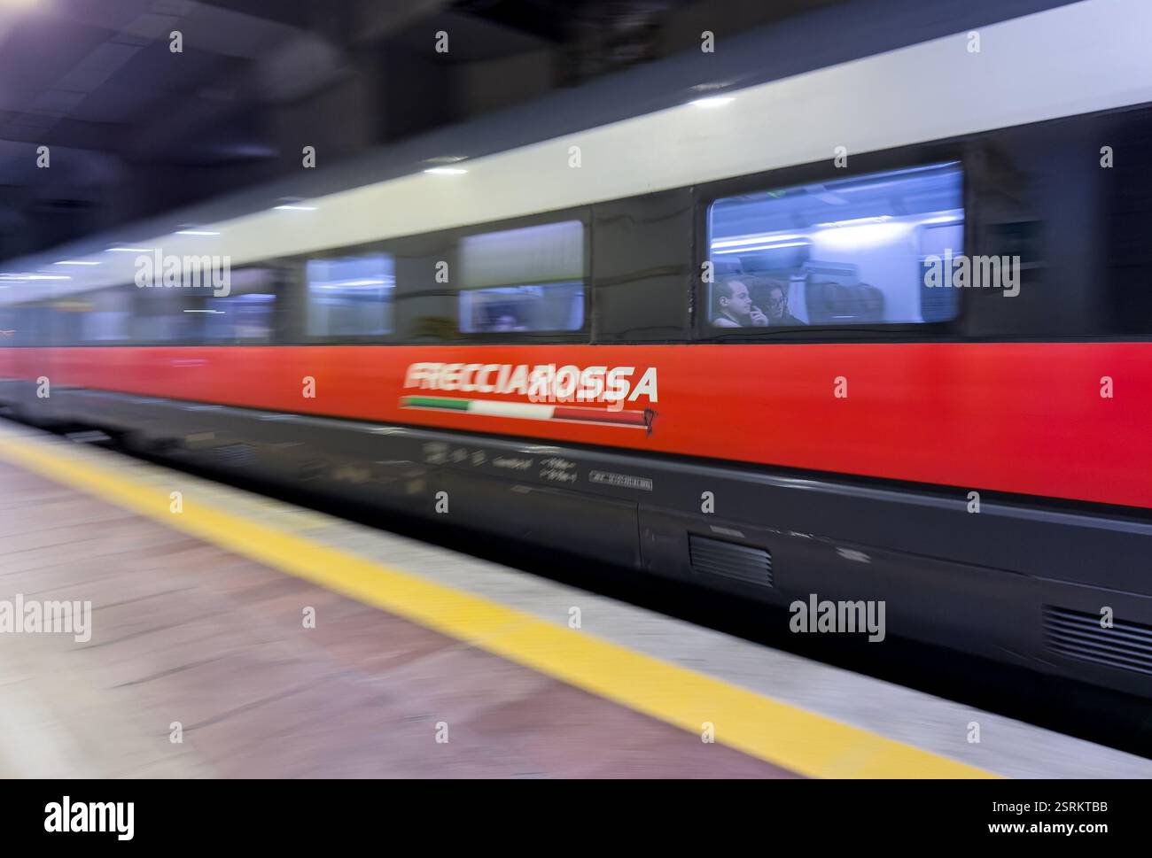 BOLOGNA, ITALY - OCTOBER 27, 2024: Red Frecciarossa ETR 1000 high speed train of Trenitalia company at Bologna Centrale main train station, heavy moti Stock Photo