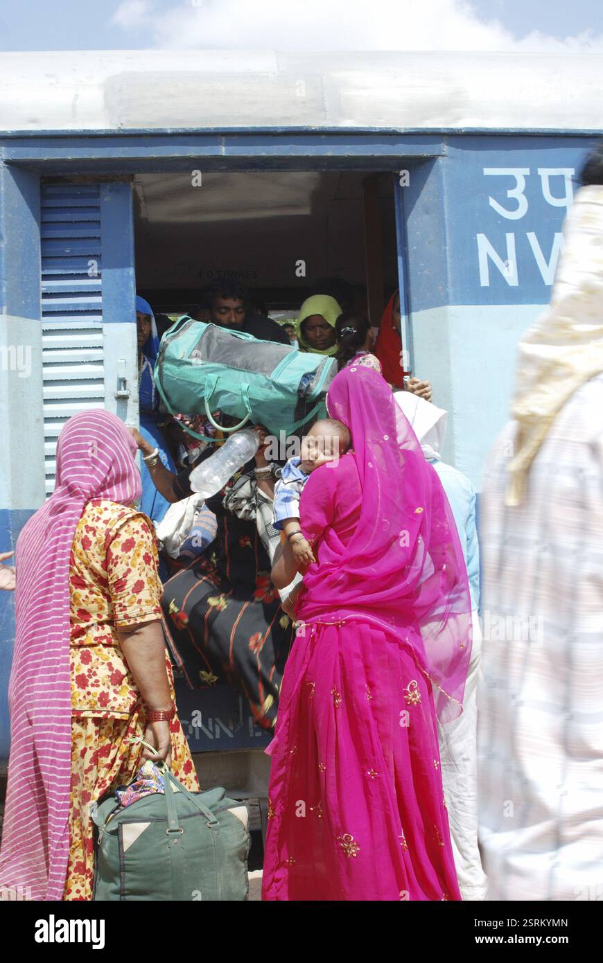 Crowd of pilgrims trying to enter a train at Runecha near Ramdevra fair, Rajasthan, India, Asia Stock Photo