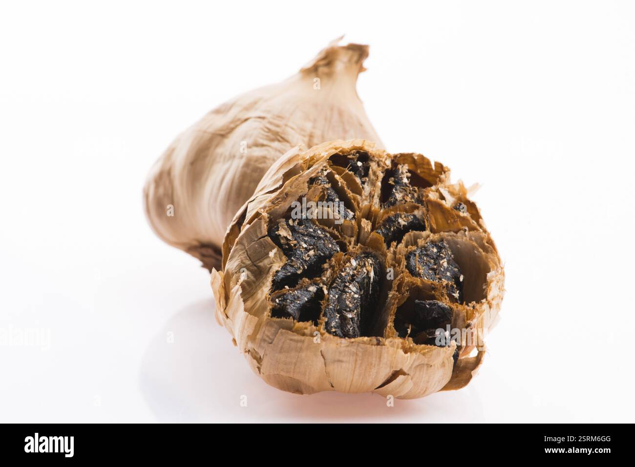 Black garlic cloves isolated on white background Stock Photo