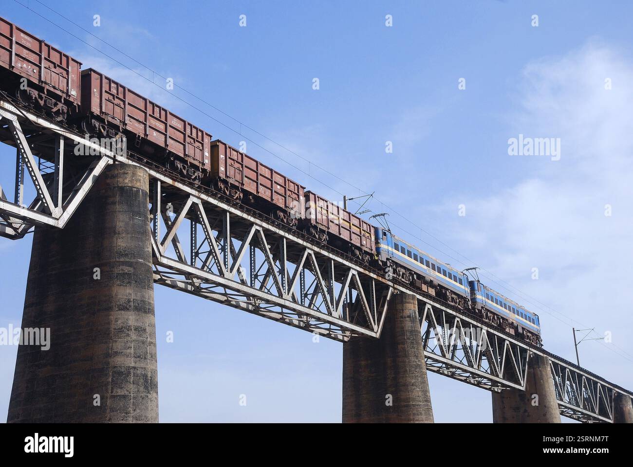 Multilit Train Multiply electric locomotive carrying freight train on bridge, Calcutta ...