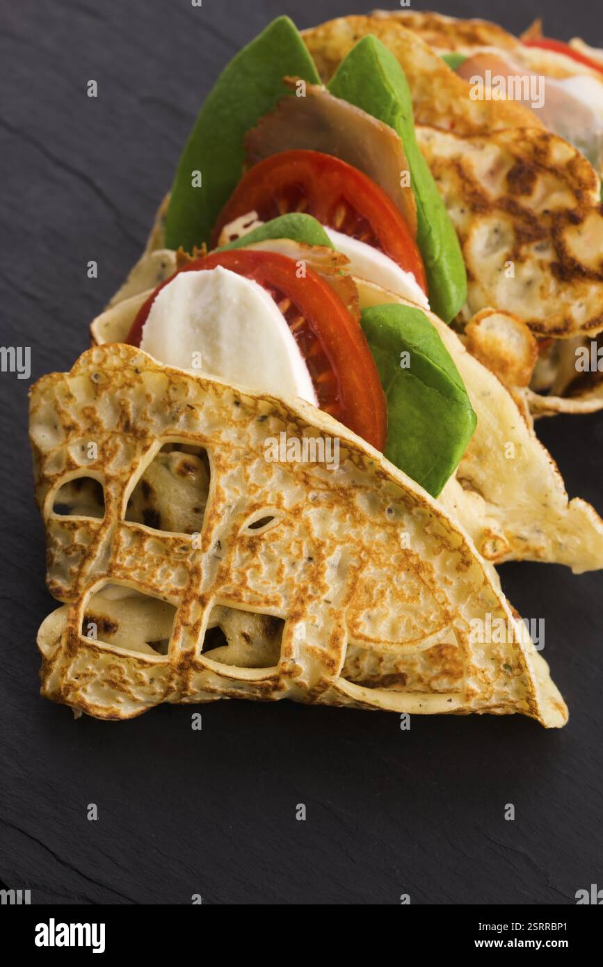 Pancakes sutffed with ham, cheese, tomatoes and spinach Stock Photo