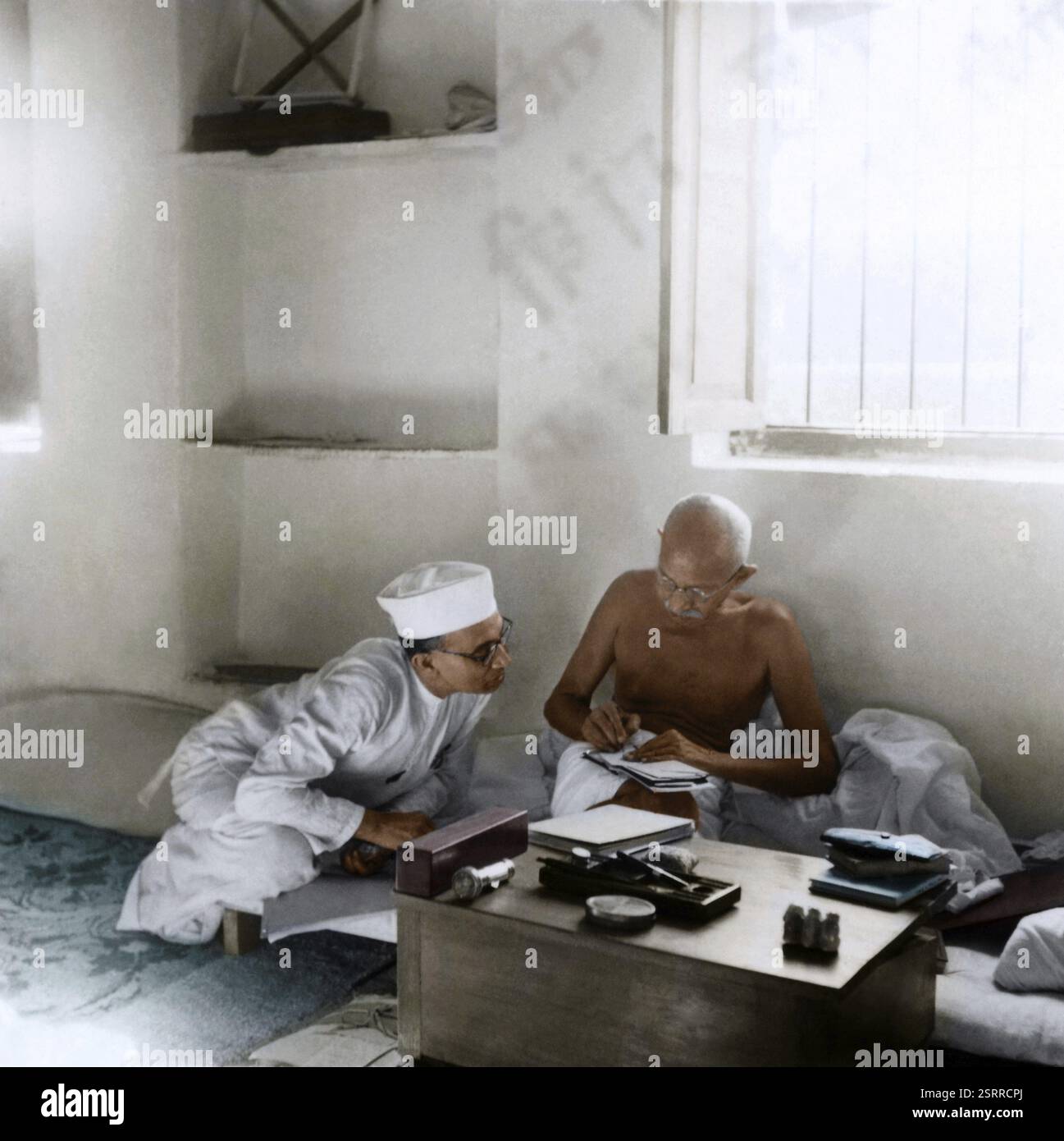 Mahatma Gandhi talking with Pyarelal Nayar, Bhangi Colony, Delhi, India ...