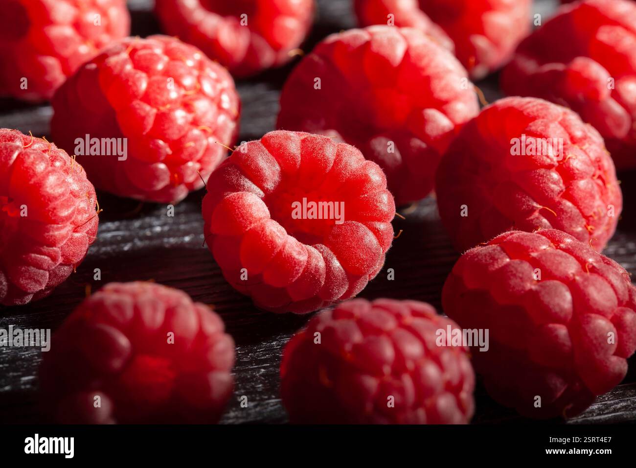 raspberry on black wood background Stock Photo