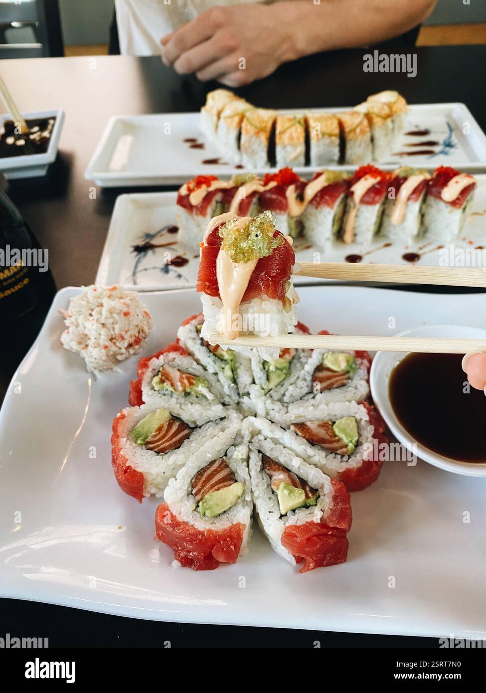 Piece of sushi held by chopsticks - Smartphone Captured Stock Image
