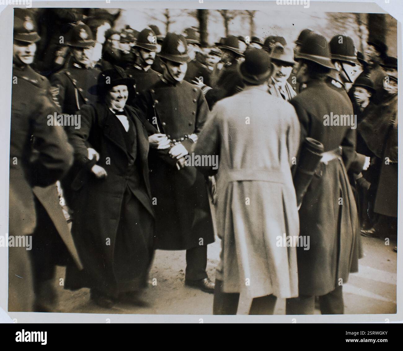 Flora Drummond being arrested by police, bystanders looking on;.1914.   Archive women's vote photograph Stock Photo