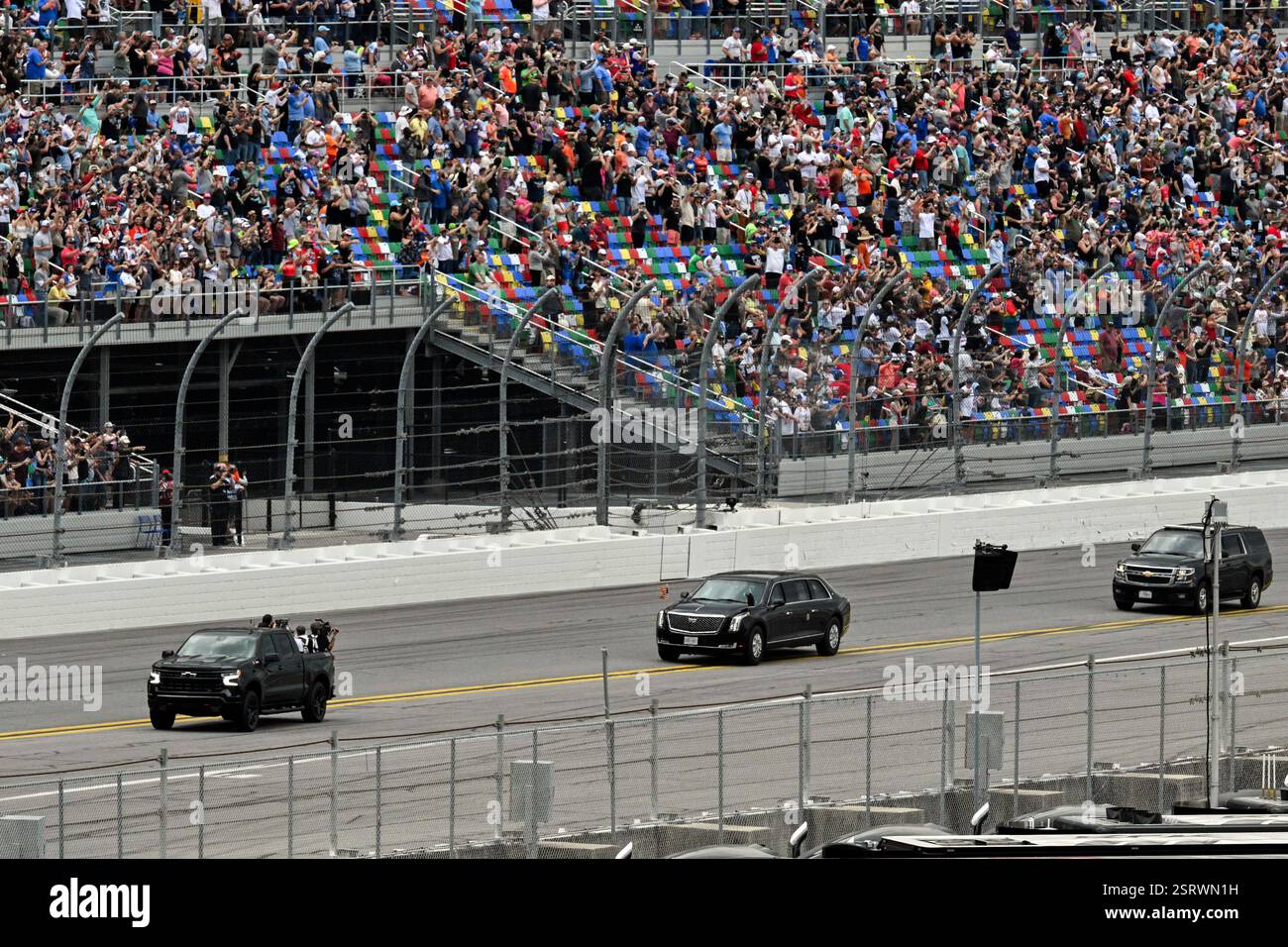 President Donald Trump, center, in the presidential limousine known as ...
