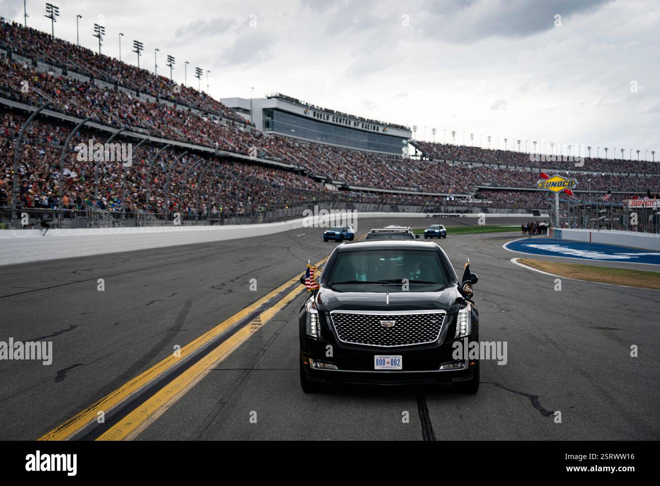 President Donald Trump rides in the presidential limousine known as ...