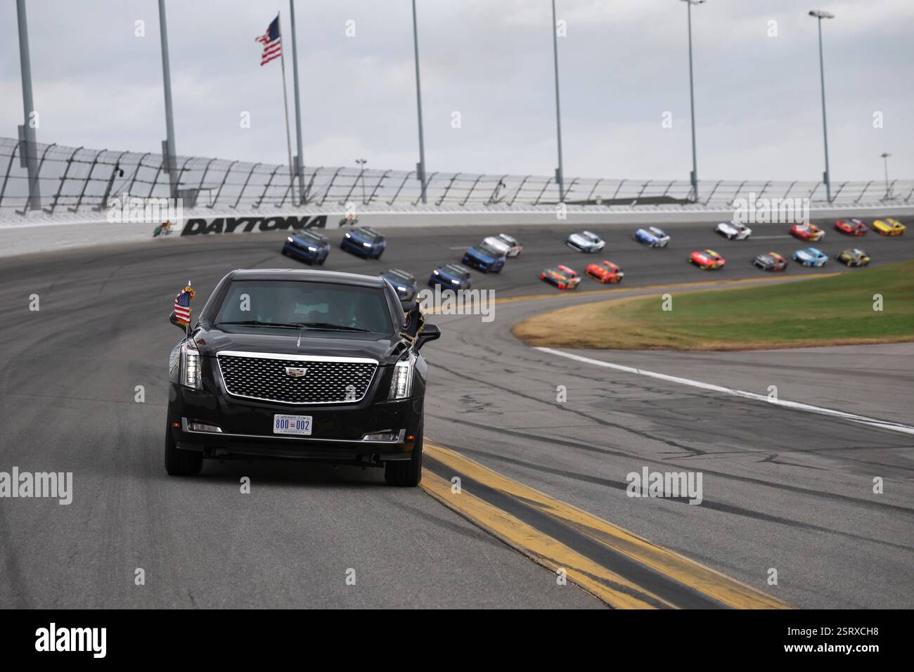 President Donald Trump rides in the presidential limousine known as ...
