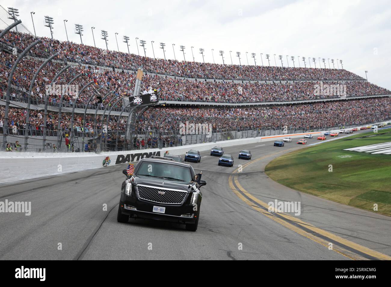 President Donald Trump rides in the presidential limousine known as ...