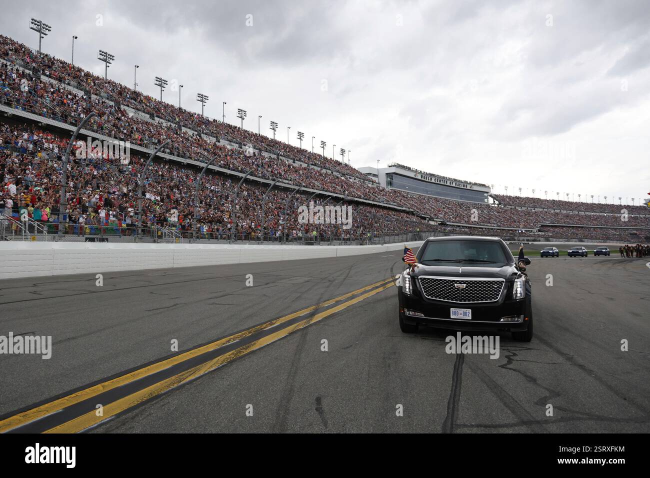 President Donald Trump rides in the presidential limousine known as ...