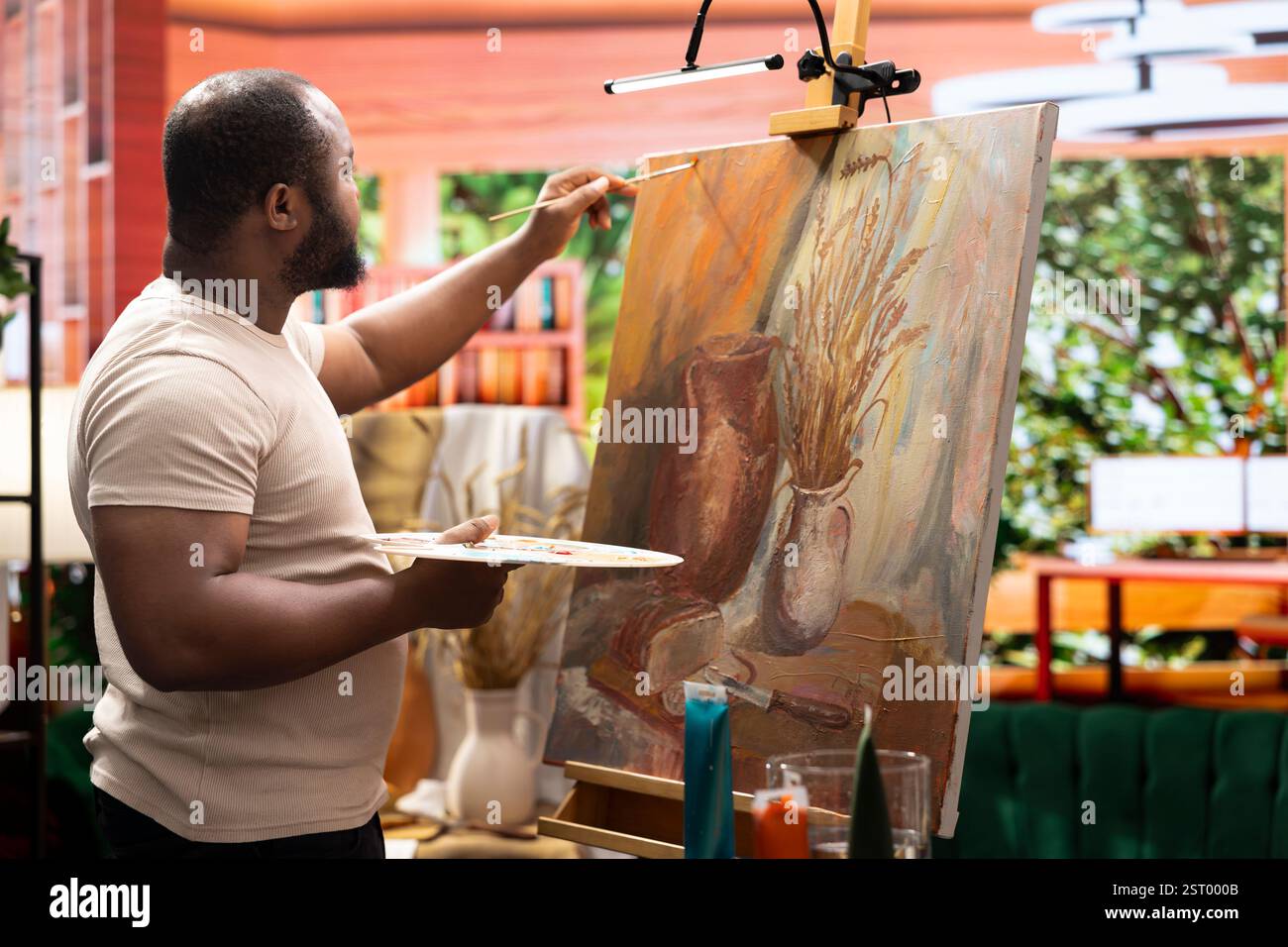 Paint Working Painter uses a variety of brushes and paint tubes to create a ...