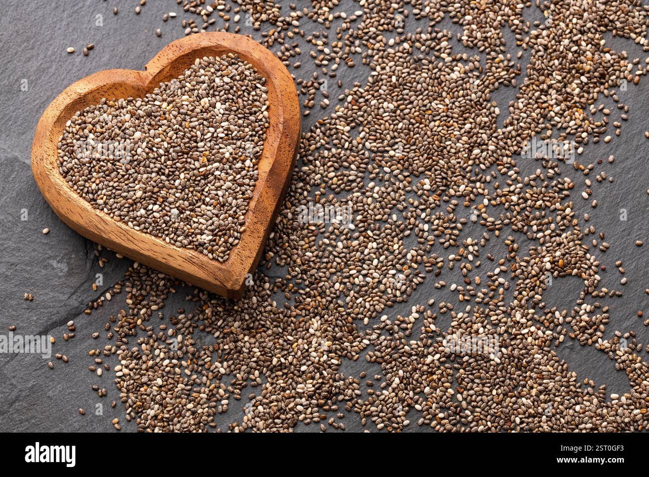 Fresh organic chia seeds in heart shaped container - Salvia hispanica ...