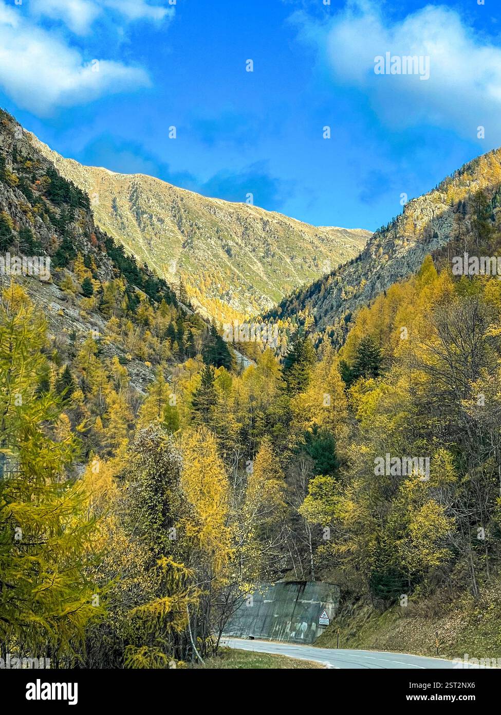 Autumn season in Montains road A winding road cutting through a breathtaking mountainous landscape. The rugged peaks, dotted with golden forests - Smartphone Captured Stock Image Autumn season in Montains road A winding road cutting through a breathtaking mountainous landscape. The rugged peaks, dotted with golden forests - Smartphone Captured Stock Image