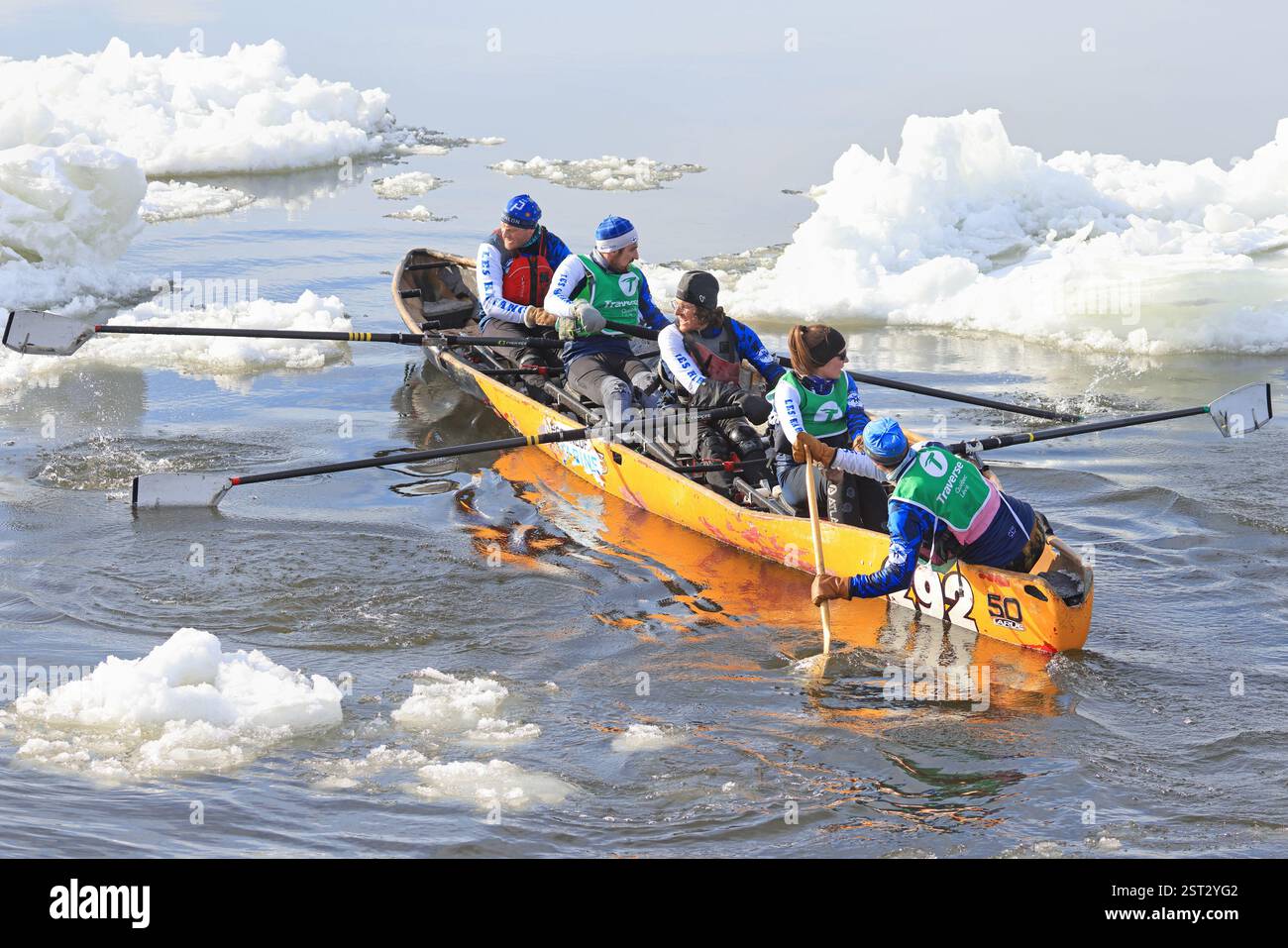 Traditional Ice Canoe Race on frozen Saint Lawrence River from Quebec to Levis during Quebec winter Carnival. Stock Photo