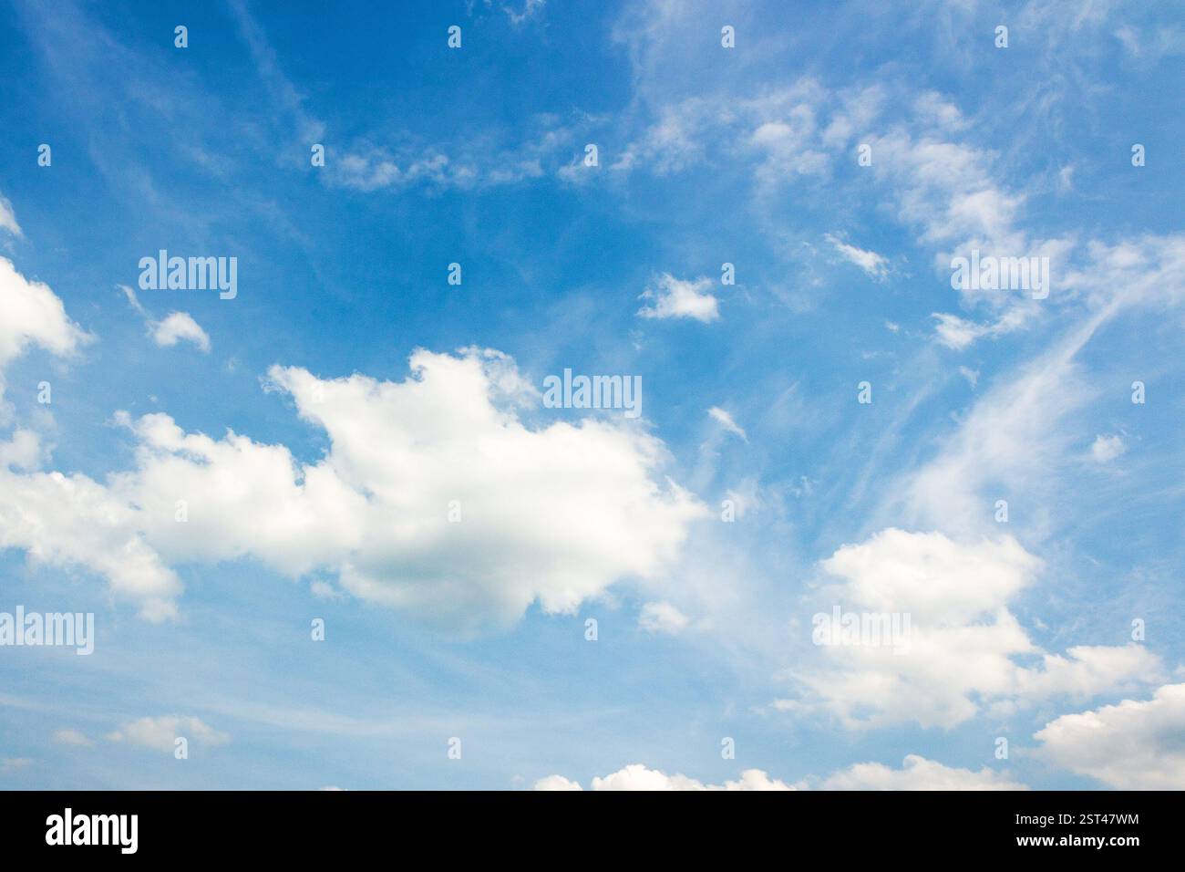 sky with fluffy clouds. natural environment. white cumulus cloudscape on a blue gradient of atmosphere. sunny summer weather. scenic nature background Stock Photo