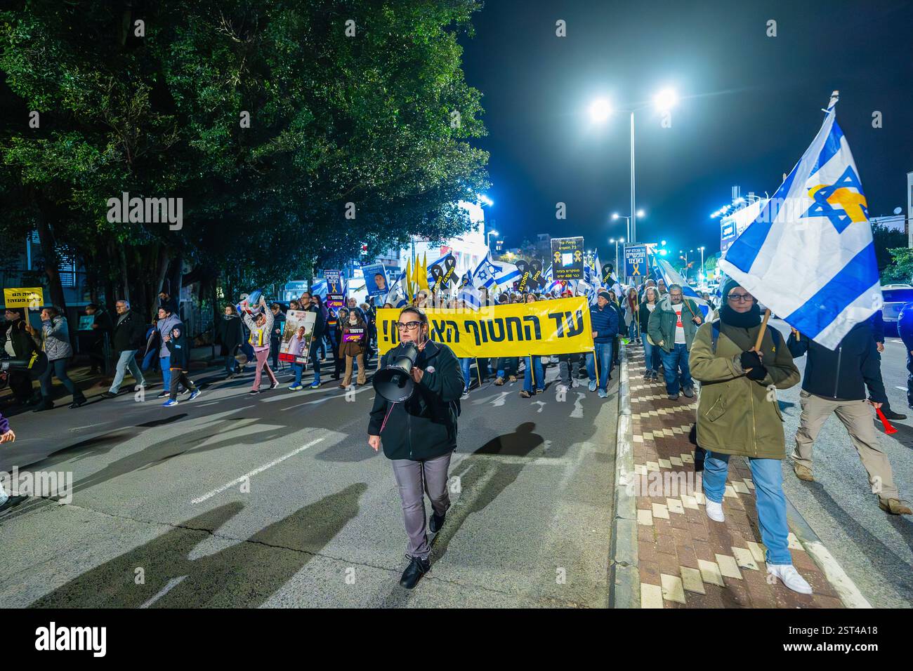 Haifa, Israel - February 15, 2025: People with various signs and flags ...