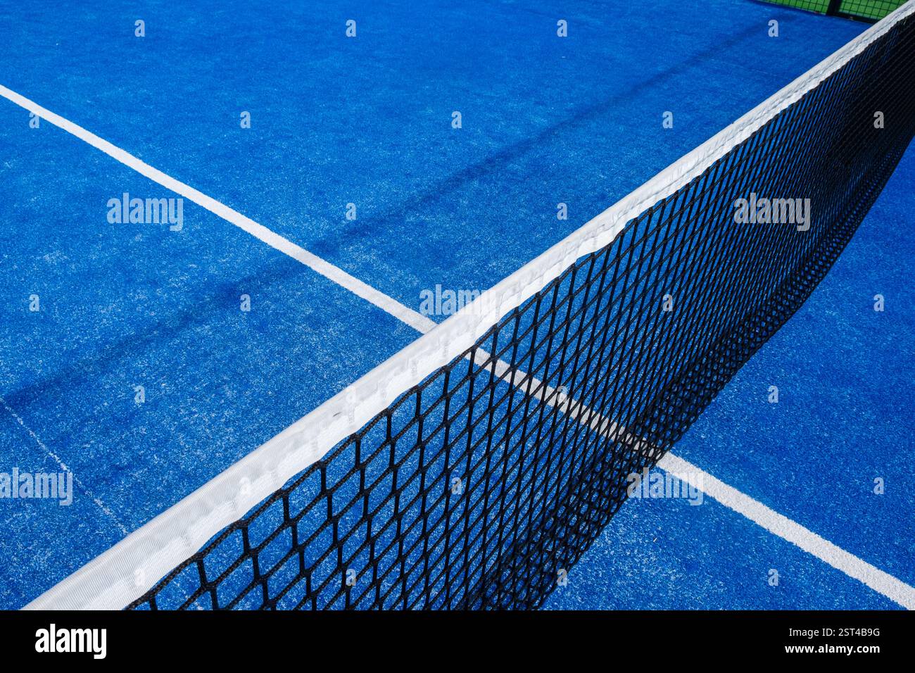 view from the top of the net on a blue padel tennis court, racket ...