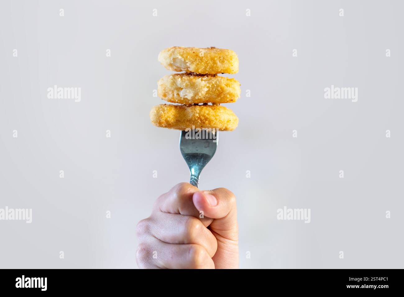 minimal fried chicken on fork In the hand Stock Photo