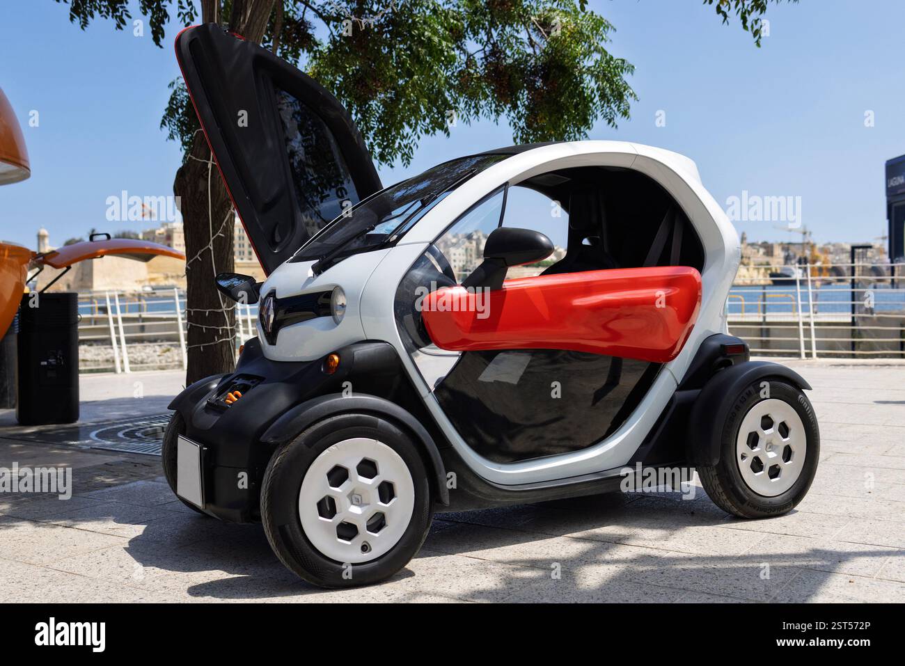 Curated visual reference: Compact Electric Car With Open Doors Parked By The Waterfront Photo Inspiration