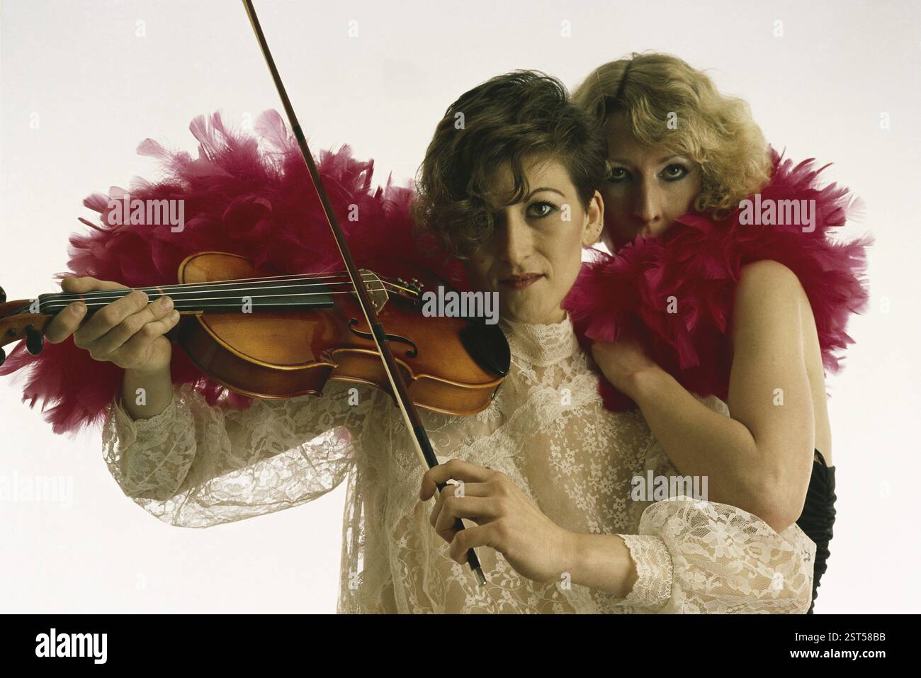 Two Dancers, one playing musical instrument violin Stock Photo - Alamy