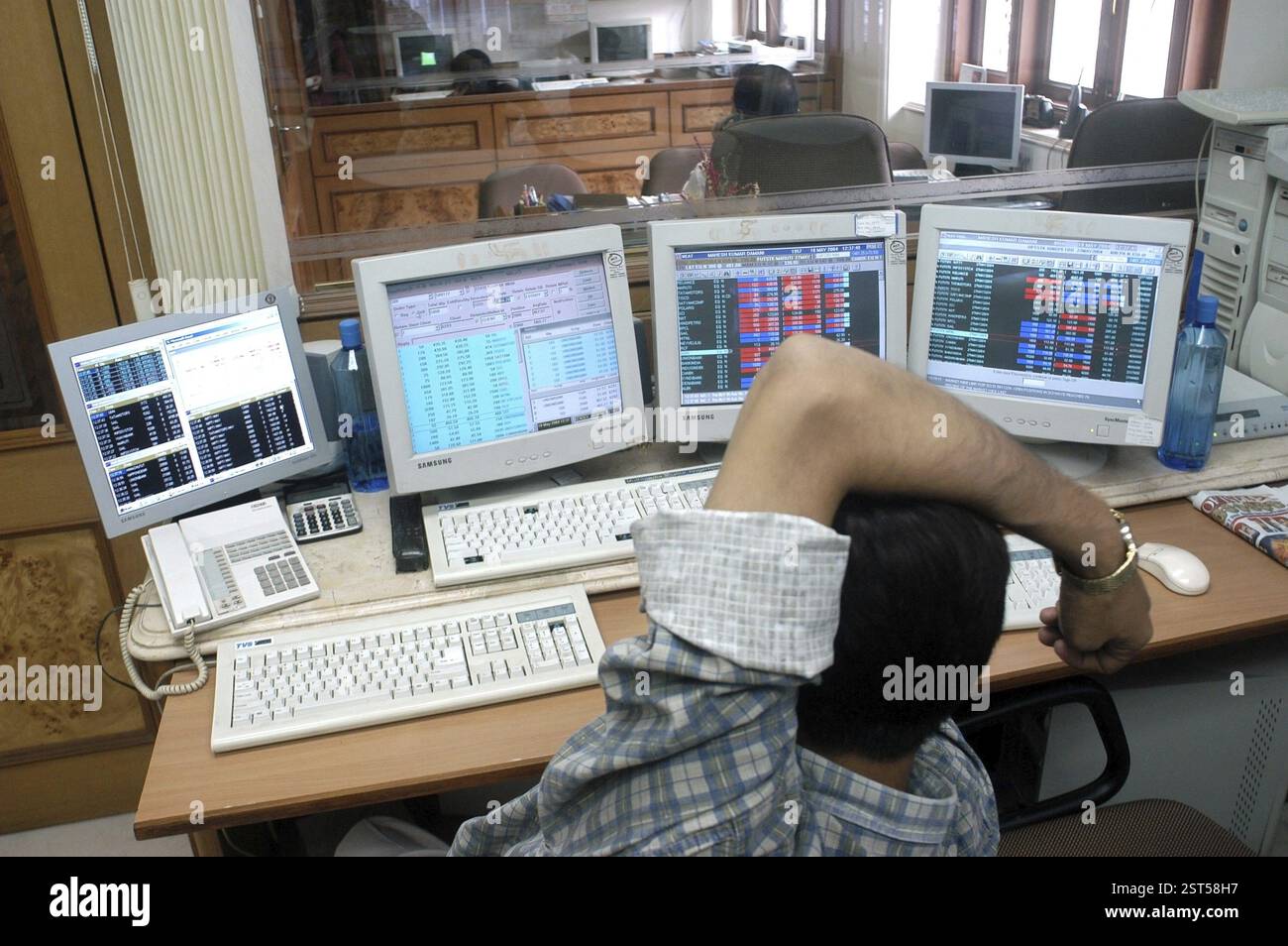 Persons at a office of a stock brokers working online share trading on the Bombay Stock Exchange (BSE) in Bombay now Mumbai in Maharashtra, India, Asi Stock Photo