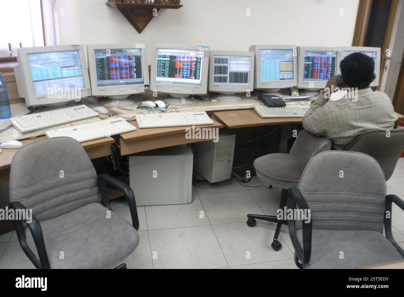 Persons at a office of a stock brokers working online share trading on the Bombay Stock Exchange (BSE) in Bombay now Mumbai in Maharashtra, India, Asi Stock Photo